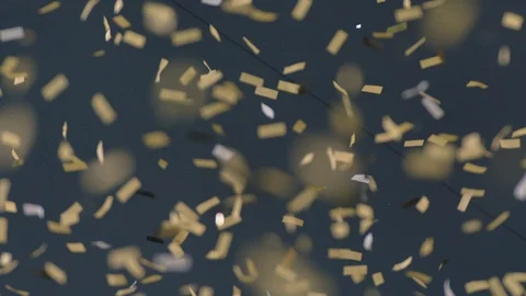 Slow motion gold confetti floating in air in stadium Stock Footage 104773536