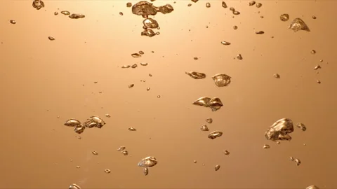 Slow motion: Gold, underwater bubbles rising to the surface. UHD29.97p Stock Footage 247961836