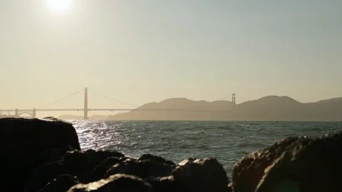 Slow Motion: Golden Gate Bridge over sea by silhouette mountains - San Francisco Видео 149717045