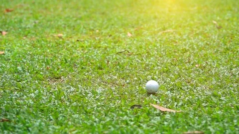 Slow motion golfer hitting golf ball on fairway in golf course Stock Footage 82726231