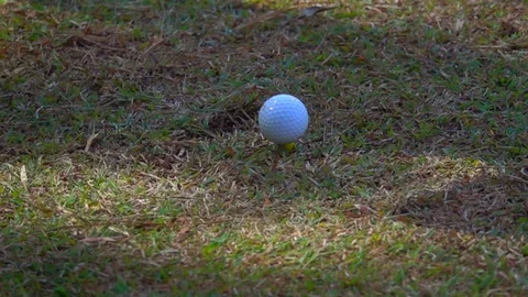 Slow motion golfer hitting golf ball on tee in golf course, tee off action shot Video stock 120585586