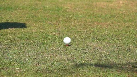 Slow motion golfer hitting golf ball on tee in golf course, tee off action shot Stock Footage 120585785