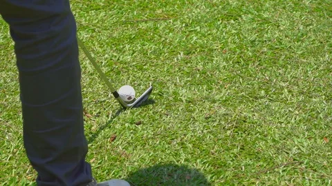 Slow motion golfer hitting swing golf ball on fairway in golf course Stock Footage 106858779