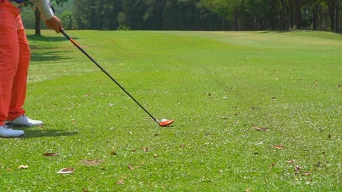 Slow motion golfer hitting swing golf ball on fairway in golf course Stock Footage 106860132