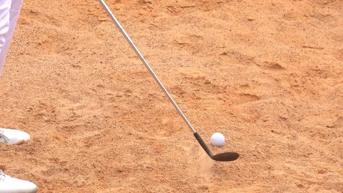 Slow motion golfer swing golf ball on sand bunker to hold in golf course Stock Footage 88408295