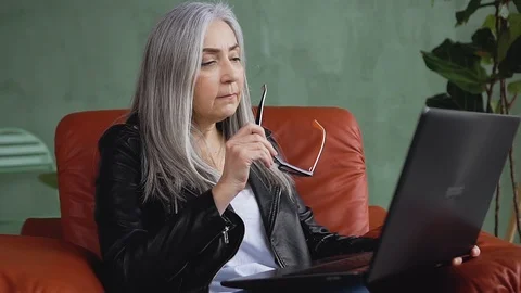 Slow motion of good-looking satisfied modern stylish lady in glasses which Stock Footage 125105301