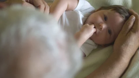 Slow motion of grandfather caressing baby's head Stock-Footage 114103641
