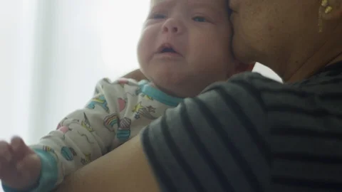 Slow motion of grandmother trying to console crying baby Stock-Footage 113940096
