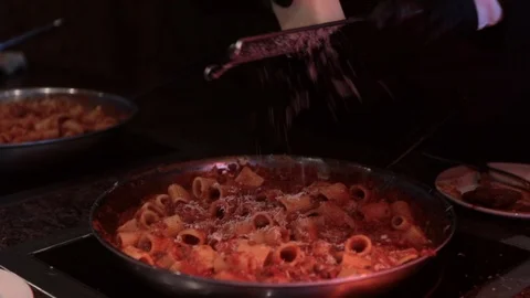 Slow motion grating parmesan on pasta sauté pan Stock-Footage 106052720