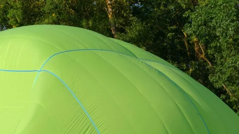 Slow motion green balloon envelope sail inflating for the flight. Stock Footage 114303793