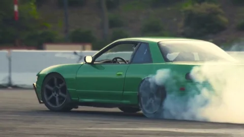 Slow motion green car drifting Stock Footage 78964790