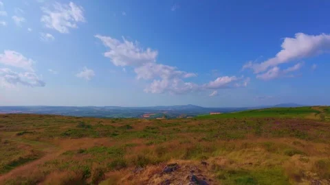 Slow motion green rolling hills and valley view on sunny day Stock Footage 340441483