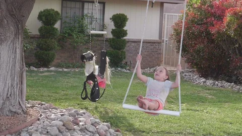 Slow Motion Gril Swinging on Tree Swing Stock Footage 129383935
