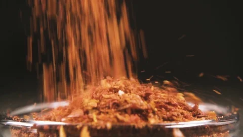 Slow motion ground paprika falling into a bowl close up Stock Footage 95783616