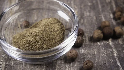 Slow motion ground pepper pour into bowl close-up Video stock 95795507