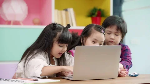Slow motion - Group of children using laptop in classroom. Stock Footage 111590704