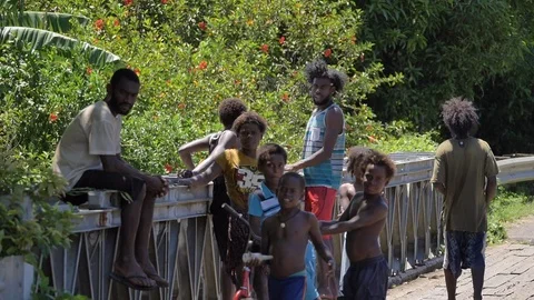 SLOW MOTION Group of curious native men and children of Vanuatu look into camera Stock Footage