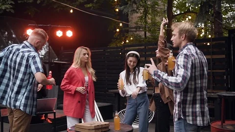 Slow motion of a group of dancing people in the gazebo in the evening Stock Footage 116655364