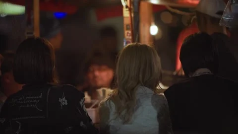 Slow motion of group dining together under warm lanterns at yatai street Japan Stock Footage 321419845