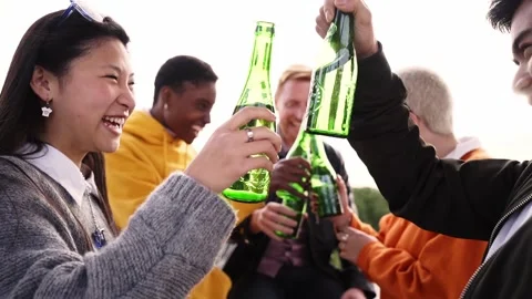Slow motion - Group of diverse people toasting playfulness outdoors drinking Stock Footage 185481770