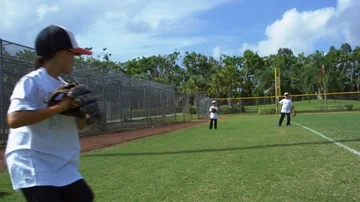 Slow motion of a group of kids throwing and catching balls at baseball park Stock Footage 85642727