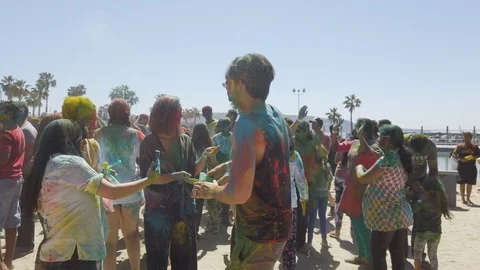 Slow motion of a group of people dancing, color holi festival Stock Footage 135316002