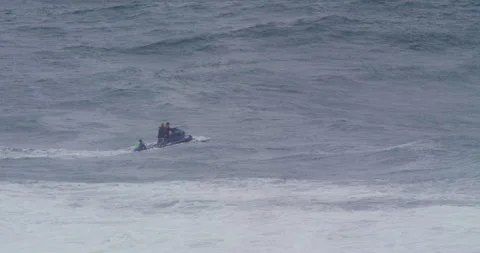 Slow motion of group of professional surfers on jet ski swinging on ocean water Stock Footage 156124367