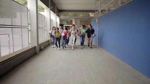 Slow motion of group of students running out of the classroom at the end of Stock Footage 188425762