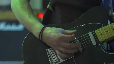 Slow motion guitar strumming / playing with soft light changes Stock Footage 130976158
