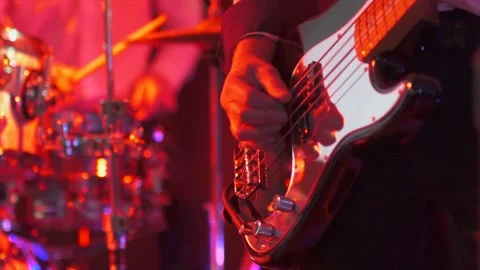 Slow motion guitar strumming / playing with soft light changes Stock Footage 130976161