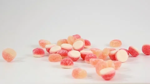Slow Motion Gummy Candies Falling on White Background Stock Footage 341848795
