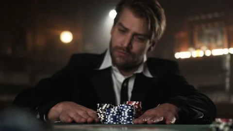 Slow motion of a guy playing Poker and going all in in a bar Stock Footage 132716189