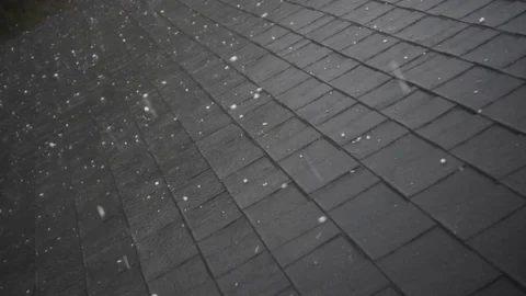 Slow motion of hail hitting home roof in thunderstorm Stock Footage