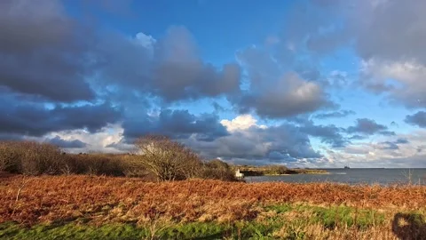 Slow motion hailstone falling across stormy north wales coast hillside Stock Footage 325663299