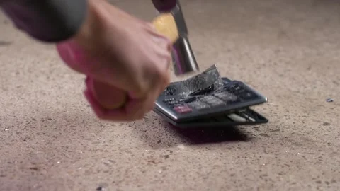 Slow motion hammer smashed calculator frustration concept damaged economy Stock Footage 145937818