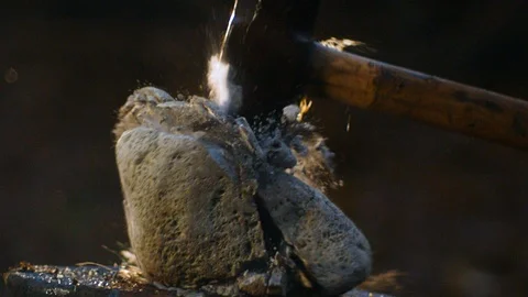 Slow motion of hammer smashing a rock into pieces. Stock Footage