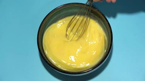 Slow Motion Hand Beat Eggs for Amlet in Bowl on Blue Table. Stock Footage 151474167