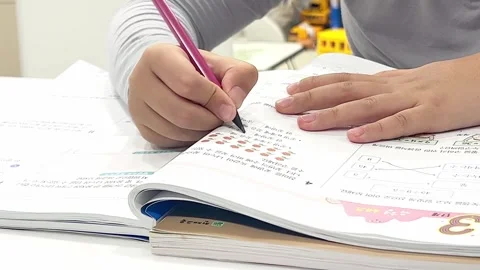 Slow motion, the hand of a child studying with a pencil in his hand Stock Footage 262646201