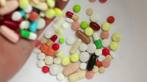 Slow motion of hand dropping medicine pills Stock Footage 23305439