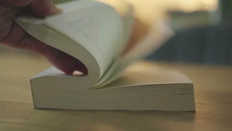 Slow motion of Hand Flipping Book Pages on Wooden Table. Education Study Concept Stock Footage 338184118