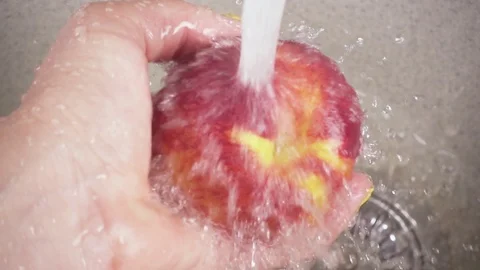 Slow motion hand with fruit under the water in the sink Stock Footage 90991293