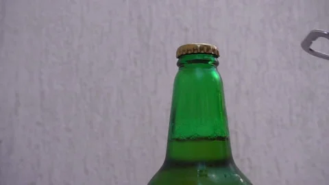 Slow motion hand with opener opens lid on bottle Stock Footage 112942316