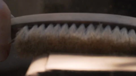 Slow motion of hand passing brush on wooden surface to clean wood dust Stock Footage 139659179