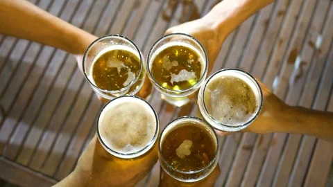 Slow motion, The hand that picked up the glass of beer collided before drinking. Stock Footage 111147736
