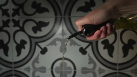 Slow motion hand pours olive oil Stock Footage 156223342