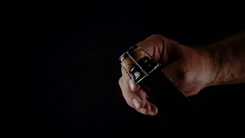 Slow motion hand removes the wire from the cork on a bottle Stock Footage 113351899