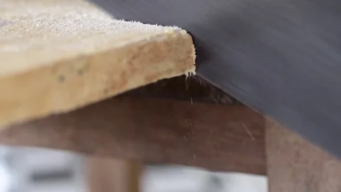 Slow motion, hand saw cutting throw wood, closeup Stock Footage 82044084