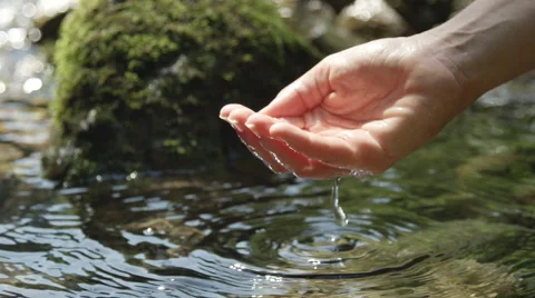 SLOW MOTION: Hand scooping fresh water in pure mountain spring Stock Footage 55729054
