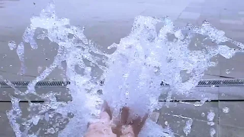 Slow motion. A hand in a stream of water. Fountain in the park. Stock Footage 157057440