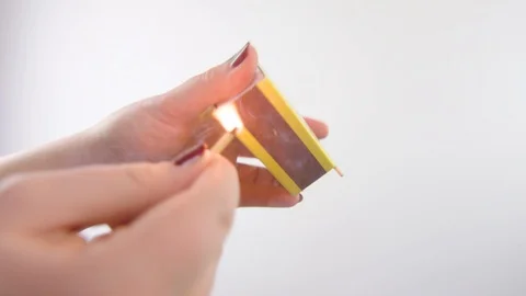 Slow motion of a hand striking and lighting a match Stock Footage 85363085